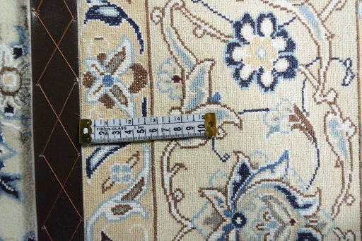 Backside of handmade New Nain rug showing knot structure and weave density