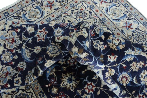 Surface texture of 2000s Nain rug with natural Wool and intricate pattern