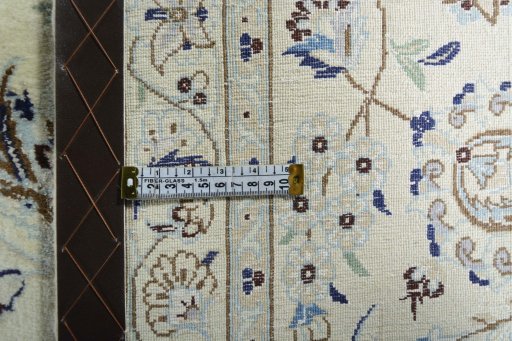 Backside of handmade New Nain rug showing knot structure and weave density