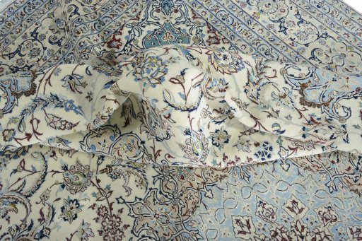 Backside of handmade New Nain rug showing knot structure and weave density