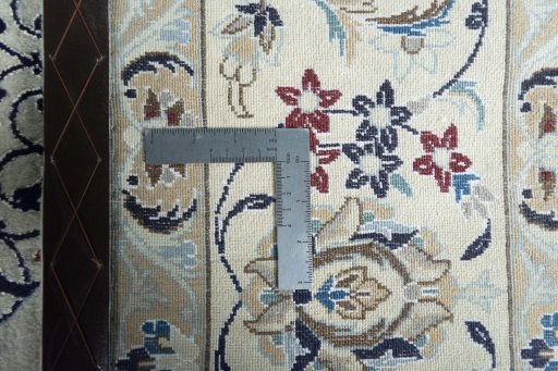 Backside of handmade New Nain rug showing knot structure and weave density