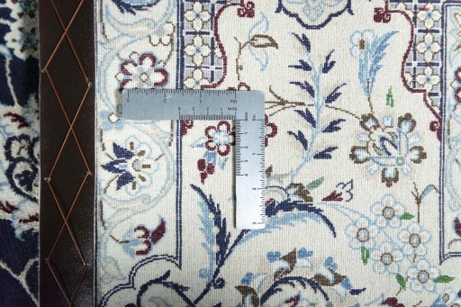 Backside of handmade New Nain rug showing knot structure and weave density