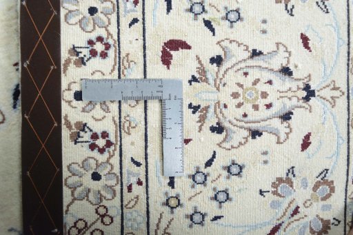 Backside of handmade New Nain rug showing knot structure and weave density