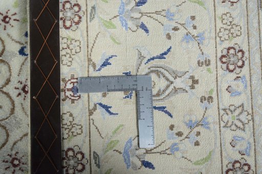 Backside of handmade New Nain rug showing knot structure and weave density