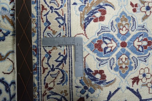 Backside of handmade New Nain rug showing knot structure and weave density