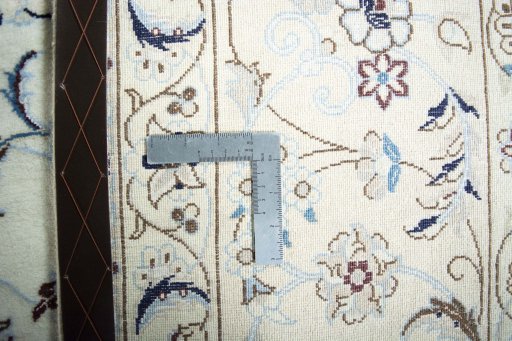 Backside of handmade New Nain rug showing knot structure and weave density
