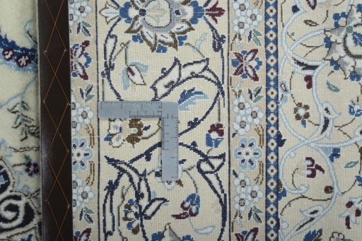 Backside of handmade New Nain rug showing knot structure and weave density