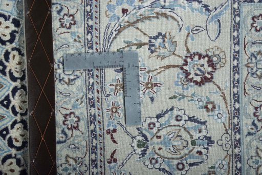 Backside of handmade New Nain rug showing knot structure and weave density