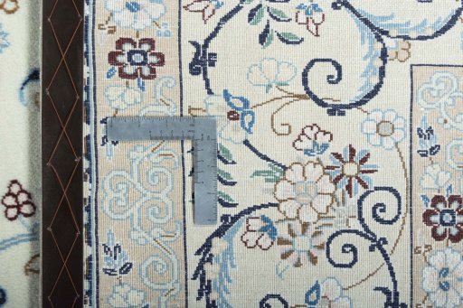 Backside of handmade New Nain rug showing knot structure and weave density
