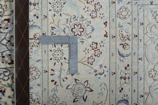 Backside of handmade New Nain rug showing knot structure and weave density