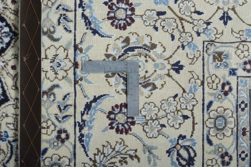 Backside of handmade New Nain rug showing knot structure and weave density