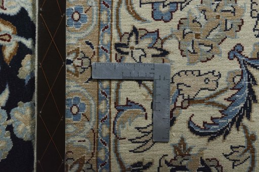 Backside of handmade New Nain rug showing knot structure and weave density