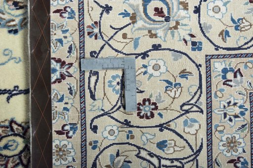 Backside of handmade New Nain rug showing knot structure and weave density