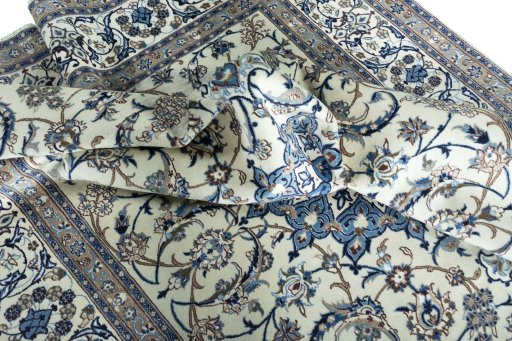 Surface texture of 2000s Nain rug with natural Wool and intricate pattern