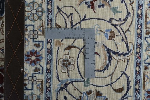 Backside of handmade New Nain rug showing knot structure and weave density
