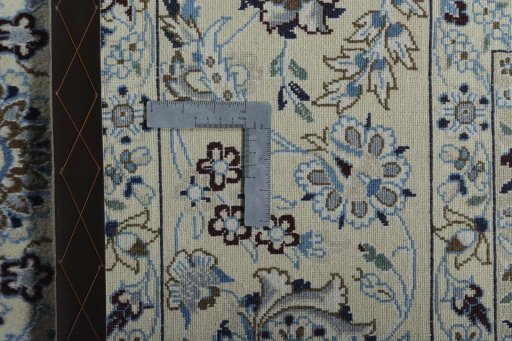 Backside of handmade New Nain rug showing knot structure and weave density