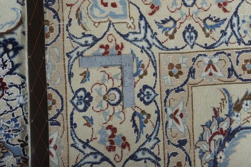 Backside of handmade New Nain rug showing knot structure and weave density