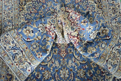 Surface texture of 2000s Nain rug with natural Wool and intricate pattern