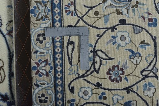 Backside of handmade New Nain rug showing knot structure and weave density