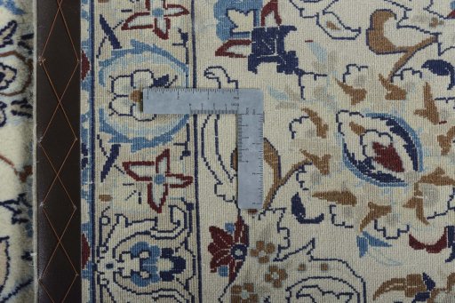 Backside of handmade New Nain rug showing knot structure and weave density