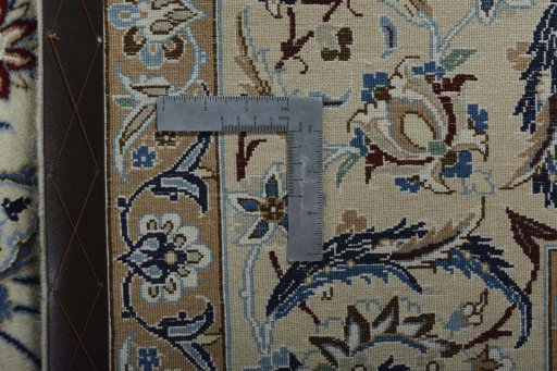 Backside of handmade New Nain rug showing knot structure and weave density