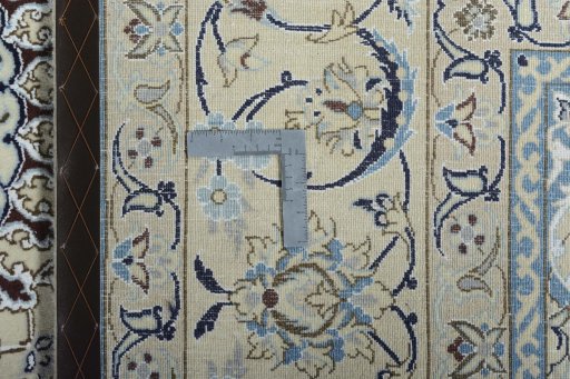 Backside of handmade New Nain rug showing knot structure and weave density