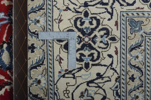 Backside of handmade New Nain rug showing knot structure and weave density