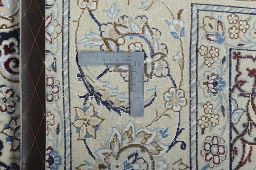 Backside of handmade New Nain rug showing knot structure and weave density