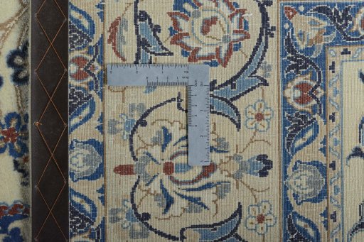 Backside of handmade New Nain rug showing knot structure and weave density