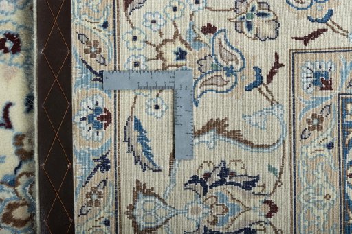 Backside of handmade New Nain rug showing knot structure and weave density