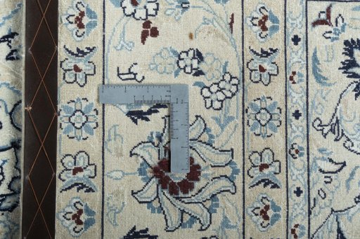 Backside of handmade New Nain rug showing knot structure and weave density