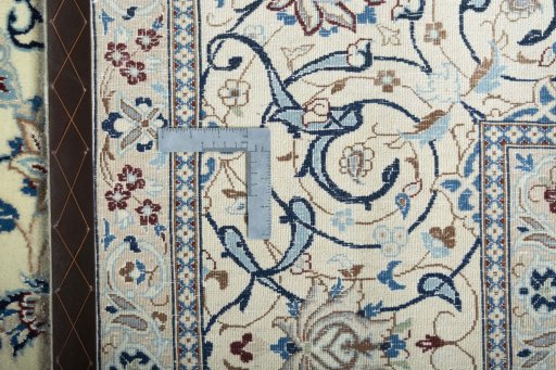Backside of handmade New Nain rug showing knot structure and weave density