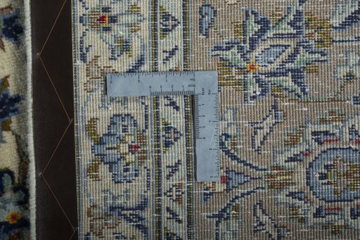 Backside of handmade New Nain rug showing knot structure and weave density