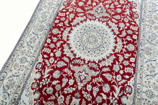 Backside of handmade New Nain rug showing knot structure and weave density