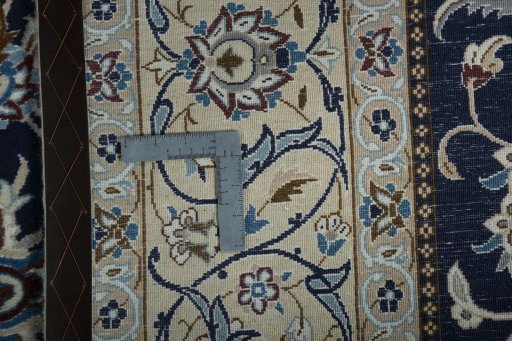 Backside of handmade New Nain rug showing knot structure and weave density