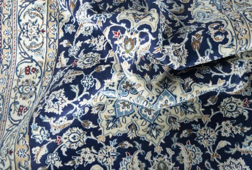 Surface texture of 2000s Nain rug with natural Wool and intricate pattern