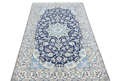 Surface texture of 2000s Nain rug with natural Wool and intricate pattern