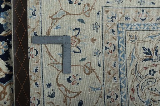 Backside of handmade 2000s Nain rug showing knot structure and weave density