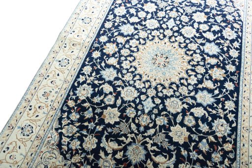 Backside of handmade 2000s Nain rug showing knot structure and weave density