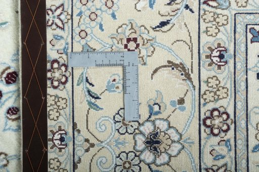 Backside of handmade New Nain rug showing knot structure and weave density