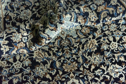 Surface texture of 2000s Nain rug with natural Wool and intricate pattern