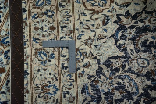 Backside of handmade 2000s Nain rug showing knot structure and weave density