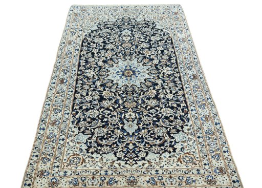 Surface texture of 2000s Nain rug with natural Wool and intricate pattern