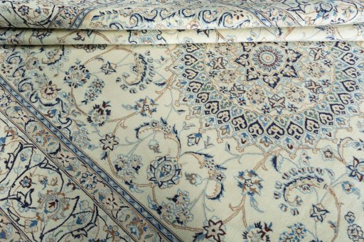 Backside of handmade New Nain rug showing knot structure and weave density