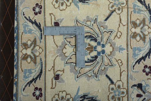 Backside of handmade New Nain rug showing knot structure and weave density