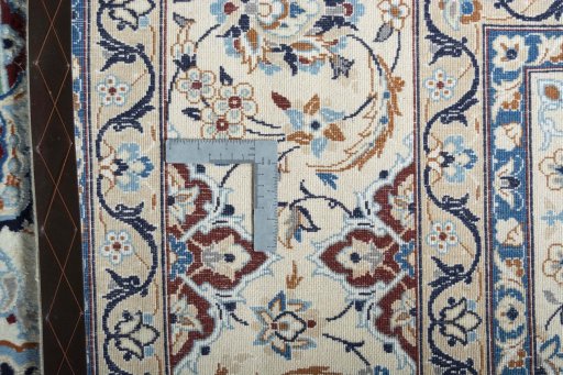 Backside of handmade New Nain rug showing knot structure and weave density
