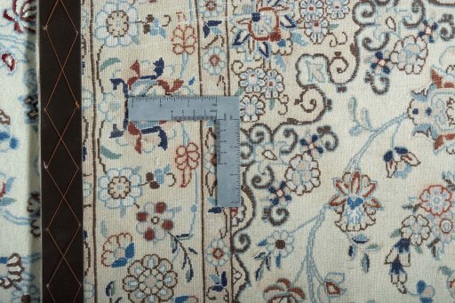 Backside of handmade New Nain rug showing knot structure and weave density