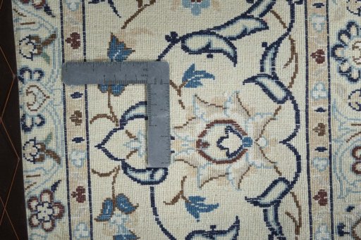 Backside of handmade 2000s Nain rug showing knot structure and weave density