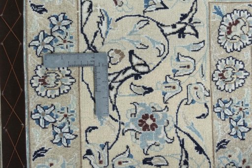 Backside of handmade New Nain rug showing knot structure and weave density
