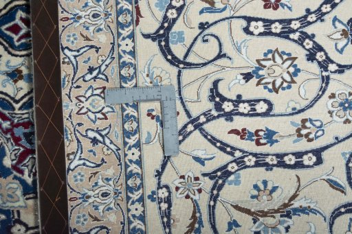 Backside of handmade New Nain rug showing knot structure and weave density